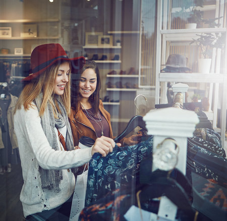 But I already have something like this. two best friends out shopping in a clothing store.の写真素材