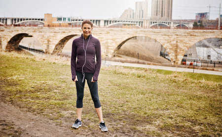 Nothing beats a morning run. Full length portrait of an attractive young woman listening to music...