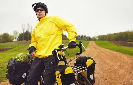Dont let the weather stop you from cycling. a male cyclist enjoying a bike ride on a wet winters...