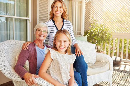 The women of the family. Cropped portrait of a young girl sitting outside with her mother and grandmother.の写真素材