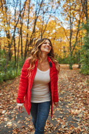 Loving all the colours of autumn. an attractive young woman in the forest during autumn.の写真素材