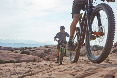 Live your passion. two athletic men mountain biking through the wilderness.の写真素材