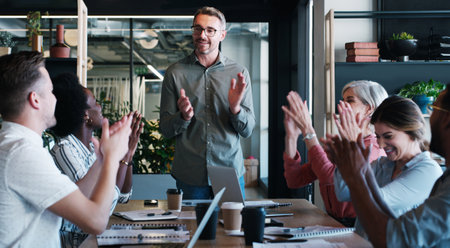 Positivity is the ultimate productivity booster. a group of businesspeople clapping during a meeting in a modern office.の写真素材