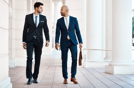 They looking dashing on their way to the office. young handsome businessmen talking outside.の写真素材