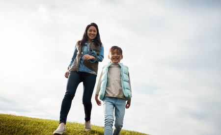 Were out for some healthy fun. an attractive young woman and her daughter in the park.の写真素材