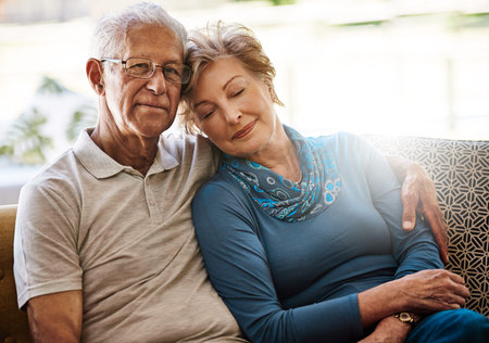 Shes given me such a wonderful life. Portrait of a senior couple relaxing together on the sofa at...