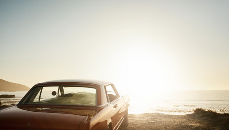 Discover the beauty out there. Still life shot of a car parked along the coast at dusk.の写真素材