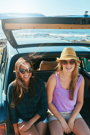 The best place to be in the summer. two friends on a road trip near the ocean.