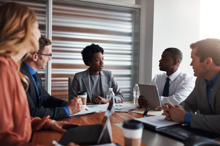 They maintain strong focus when it comes down to business. a group of businesspeople having a meeting in an office.の写真素材