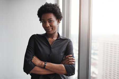 Shes ready for whatever you throw at her. Portrait of a professional businesswoman standing in an office.の写真素材