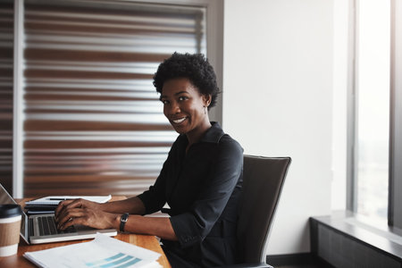 Success is mine for the taking. Cropped portrait of an attractive businesswoman working in her corporate office.の写真素材