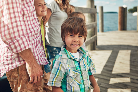 These are the moments he will cherish forever. a young family on a pier while out by the lake.の写真素材
