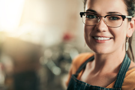 The smile of small business success. Portrait of a young barista working in her coffee shop.の写真素材
