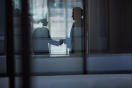 It was a pleasure to meet you. two businessmen shaking hands in the office.の写真素材
