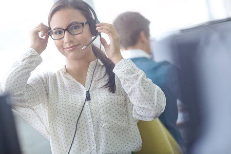 Awaiting your call 247. an attractive young customer service representative working at her desk in...