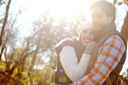 Falling in love in Fall. A loving young couple embracing outside.