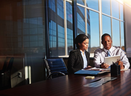 The perfect pair. two young businesspeople meeting in the boardroom.の写真素材