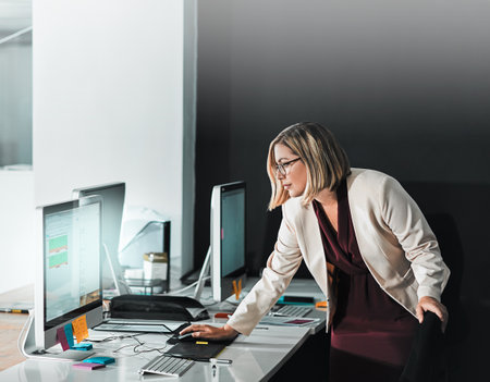 Manage your energy not your time. a businesswoman editing a sheet on her computer.の写真素材