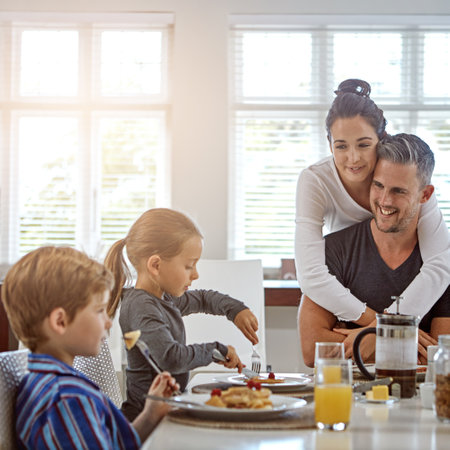 Refuelling their bodies for the day ahead. a family having breakfast together.の写真素材