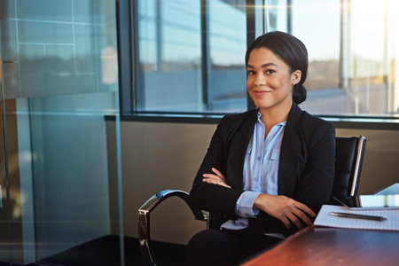 Your smile is your logo. a businesswoman sitting at her desk.