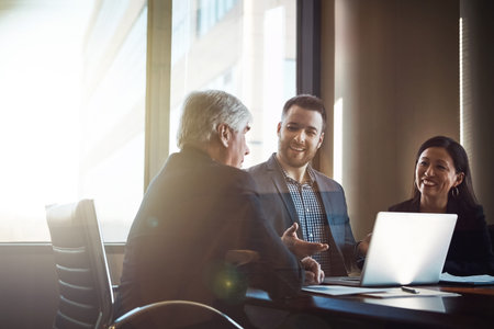 Business booms in the boardroom. three businesspeople working in the boardroom.