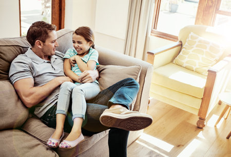 Fun times with Dad. a father and his little daughter bonding together at home.の写真素材