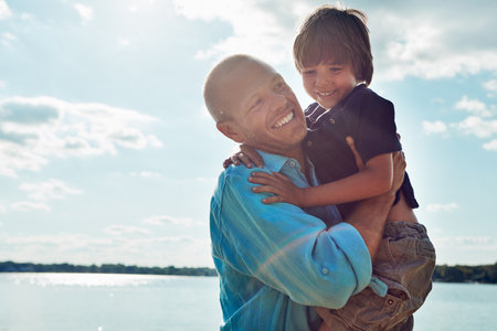 Making some amazing memories at the beach. a middle-aged man and his young son spending some quality time at the beach.の写真素材