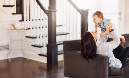 You deserve all the love this life has to offer. an adorable baby girl bonding with her mother on the sofa at home.の写真素材