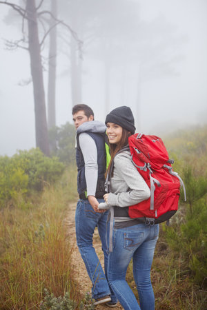 Into the woods. Portrait of a beautiful young woman out hiking with her boyfriend.の写真素材