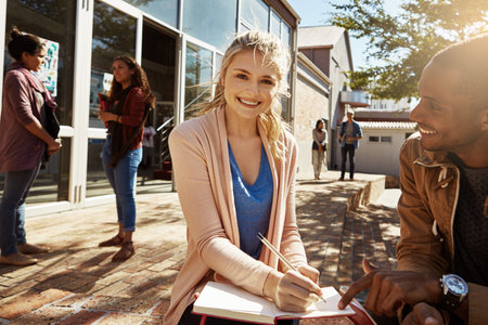 Try to always be positive. two students studying together on campus.の写真素材