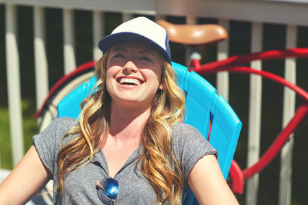 Easygoing days are just my thing. an attractive young woman relaxing on a deck chair outdoors.
