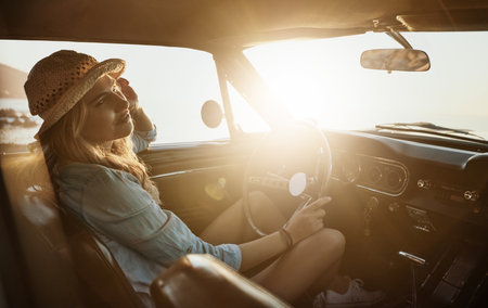 Road-tripping in style. a young woman enjoying a road trip along the coast.の写真素材
