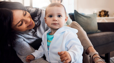 Its not a home without mom. an adorable baby girl bonding with her mother at home.