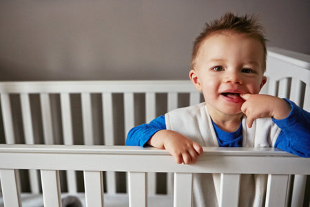 I know Its 2AM but, good morning. a cute little baby boy standing in his cot.の写真素材