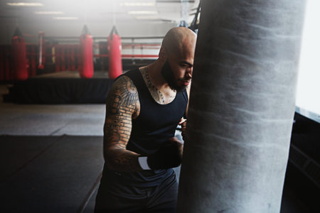 Let all your demons out. a kick-boxer training in a gym.