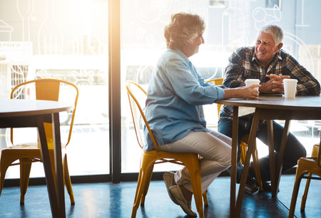 Learn from the greatest love gurus out there. a senior couple out on a date at a coffee shop.の写真素材