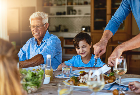 No ones going hungry today. a happy family enjoying lunch together around a table outside.