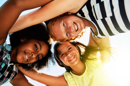 Just us girls. Portrait of a group of diverse and happy kids huddled together on a bright day...