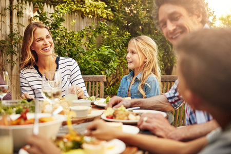 Who better to share your food with than family. a family eating lunch together outdoors.の写真素材