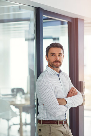 Dreams dont work unless you do. Portrait of a businessman standing in an office.