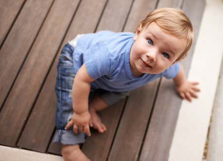 The cutest smile. an adorable little infant sitting on the floor.の写真素材