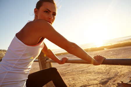 How far will you go for fitness. a beautiful woman taking a break after her jog.