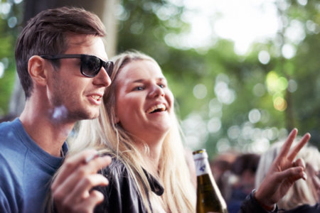 Theyre avid festival goers. a happy young couple enjoying an outdoor festival together.の写真素材