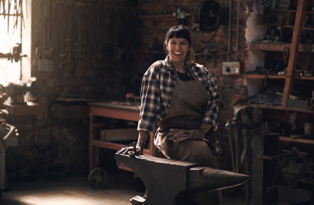 Want to see how metal is made Come visit us. Portrait of a confident young woman working at a foundry.の写真素材
