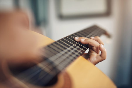 Playing an instrument is superb exercise for your mind. an unrecognizable boy playing the guitar at...