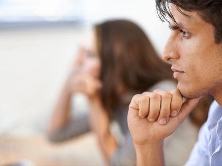 Thinking hard about his business decisions. A handsome young businessman thinking deeply.の写真素材