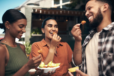 How yummy are these. a diverse group of friends standing outside a restaurant and bonding while enjoying their takeaway.の写真素材