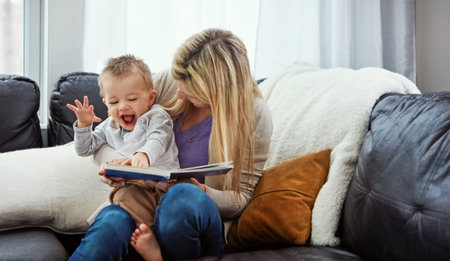 He gets so excited when its reading time. a young woman reading to her little boy.
