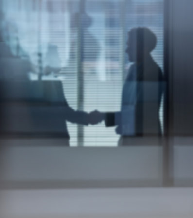 I look forward to working with you. two businessmen shaking hands in the office.の写真素材