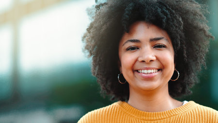 A confident African journalist student is happy about her success in class. A young black news...